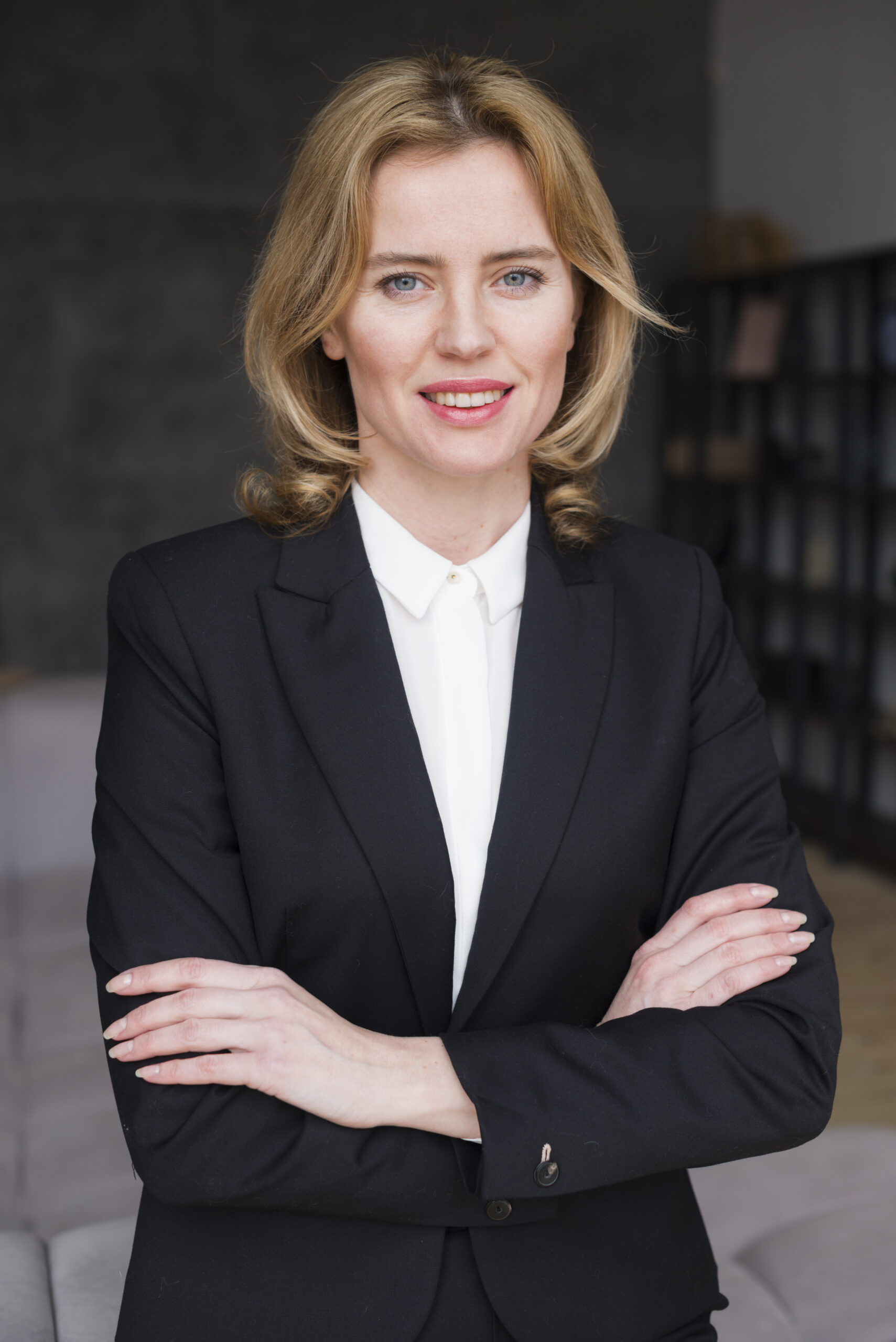 happy business woman standing with crossed arms